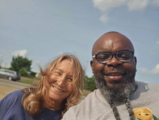 Owner with a customer outside the shop